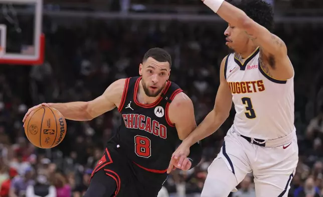 Chicago Bulls guard Zach LaVine (8) drives to the basket against Denver Nuggets guard Julian Strawther (3) during the first half of an NBA basketball game Monday, Jan. 27, 2025, in Chicago. (AP Photo/Melissa Tamez)