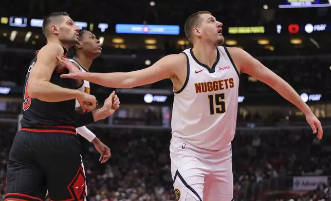 Denver Nuggets center Nikola Jokic, right, boxes out Chicago Bulls center Nikola Vucevic, left, during the first half of an NBA basketball game Monday, Jan. 27, 2025, in Chicago. (AP Photo/Melissa Tamez)