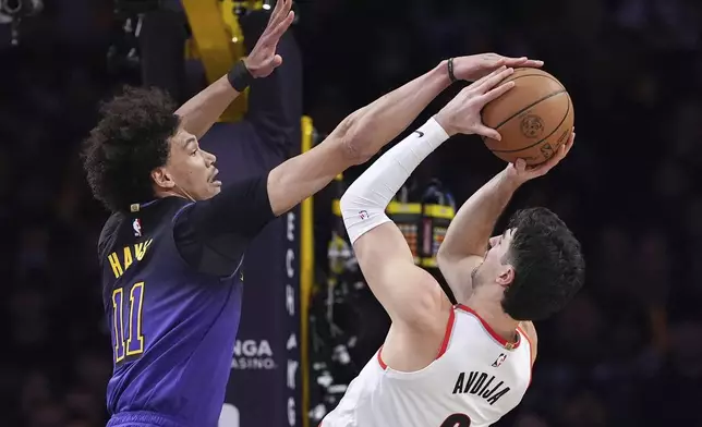 Portland Trail Blazers forward Deni Avdija, right, shoots as Los Angeles Lakers center Jaxson Hayes defends during the first half of an NBA basketball game, Thursday, Jan. 2, 2025, in Los Angeles. (AP Photo/Mark J. Terrill)