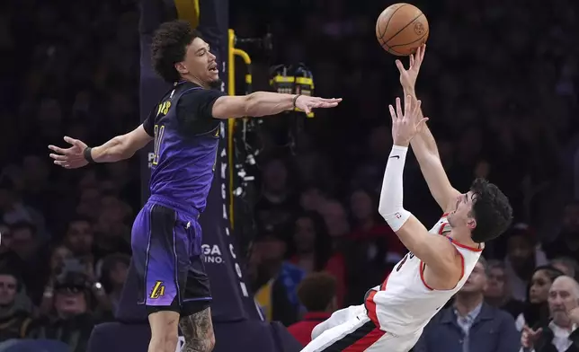 Portland Trail Blazers forward Deni Avdija, right, shoots as Los Angeles Lakers center Jaxson Hayes defends during the first half of an NBA basketball game, Thursday, Jan. 2, 2025, in Los Angeles. (AP Photo/Mark J. Terrill)