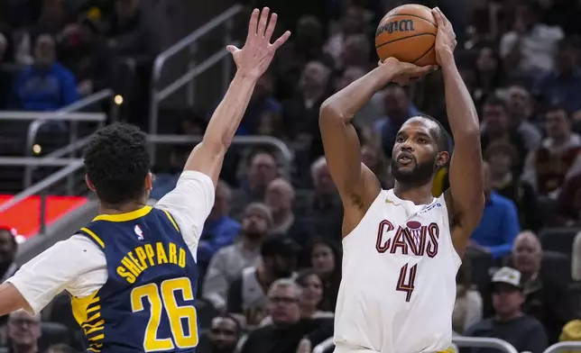 Cleveland Cavaliers forward Evan Mobley (4) shoots over Indiana Pacers guard Ben Sheppard (26) during the second half of an NBA basketball game in Indianapolis, Tuesday, Jan. 14, 2025. (AP Photo/Michael Conroy)