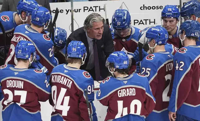 Colorado Avalanche head coach Jared Bednar, centertop, explains a play during a timeout in the third period of an NHL hockey game against the Florida Panthers, Monday, Jan. 6, 2025, in Denver. (AP Photo/David Zalubowski)