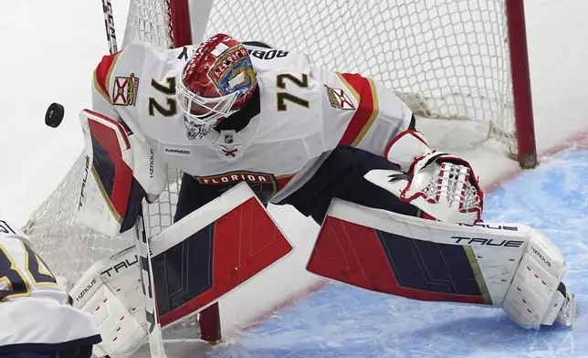 Florida Panthers goaltender Sergei Bobrovsky deflects a shot in the first period of an NHL hockey game against the Colorado Avalanche, Monday, Jan. 6, 2025, in Denver. (AP Photo/David Zalubowski)