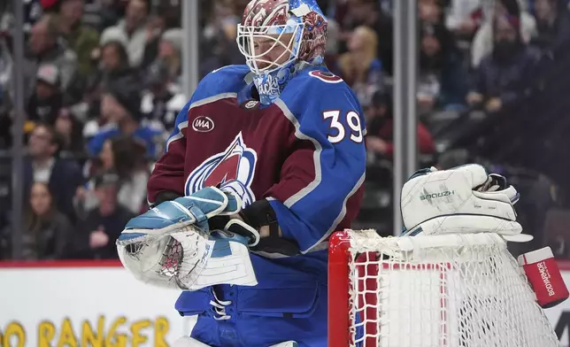 Colorado Avalanche goaltender Mackenzie Blackwood pulls on his gloves in the second period of an NHL hockey game against the Florida Panthers, Monday, Jan. 6, 2025, in Denver. (AP Photo/David Zalubowski)