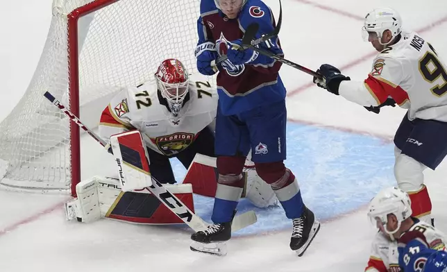 Colorado Avalanche center Juuso Parssinen, center, battles for position in front of the net between Florida Panthers goaltender Sergei Bobrovsky, left, and left wing Tomas Nosek, top right, in the first period of an NHL hockey game Monday, Jan. 6, 2025, in Denver. (AP Photo/David Zalubowski)