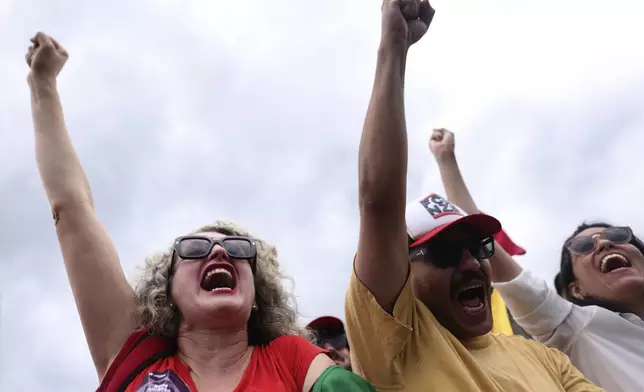 Social movement activists shout pro-democracy slogans at an event marking the second anniversary of the alleged coup attempt when supporters of former President Jair Bolsonaro invaded government buildings and called for military intervention in Brasilia, Brazil, Wednesday, Jan. 8, 2025. (AP Photo/Luis Nova)