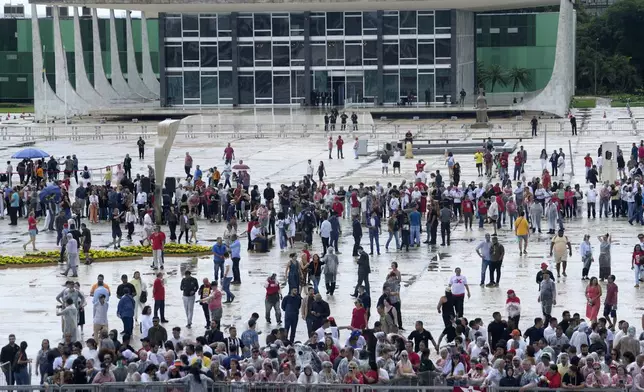 Social movement activists gather at Praça dos Tres Poderes for a pro-democracy event on the second anniversary of the alleged coup attempt when supporters of former President Jair Bolsonaro invaded government buildings and called for military intervention in Brasilia, Brazil, Wednesday, Jan. 8, 2025. (AP Photo/Eraldo Peres)