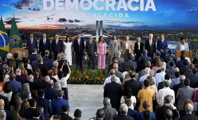 Brazilian President Luiz Inacio Lula da Silva, center holding hat, and his wife Rosangela da Silva attend a ceremony marking two years since the alleged coup attempt when supporters of former President Jair Bolsonaro invaded government buildings and called for a military intervention in Brasilia, Brazil, Wednesday, Jan. 8, 2025. (AP Photo/Eraldo Peres)