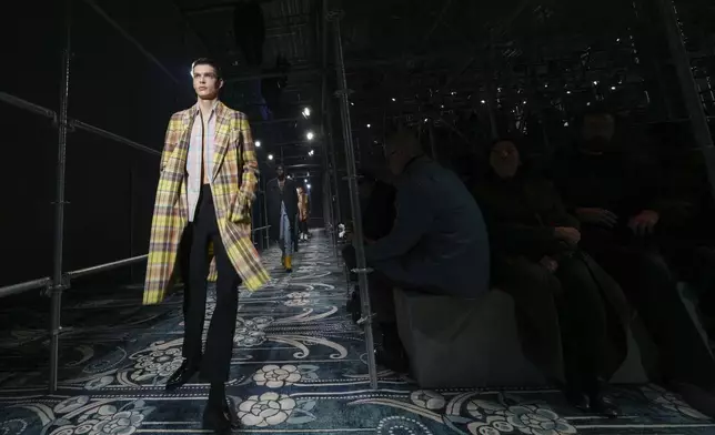 A model wears a creation part of the men's Prada Fall-Winter 2025-2026 collection, that was presented in Milan, Italy, Sunday, Jan. 19, 2025. (AP Photo/Luca Bruno)