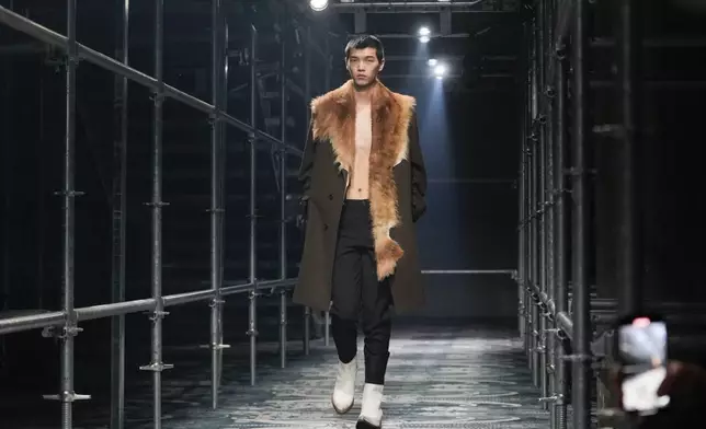 A model wears a creation part of the men's Prada Fall-Winter 2025-2026 collection, that was presented in Milan, Italy, Sunday, Jan. 19, 2025. (AP Photo/Luca Bruno)