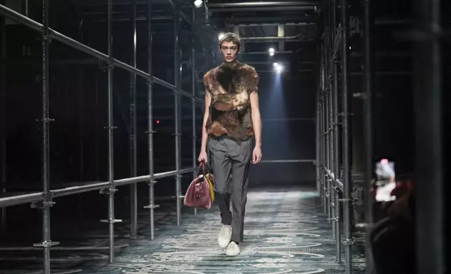 A model wears a creation part of the men's Prada Fall-Winter 2025-2026 collection, that was presented in Milan, Italy, Sunday, Jan. 19, 2025. (AP Photo/Luca Bruno)