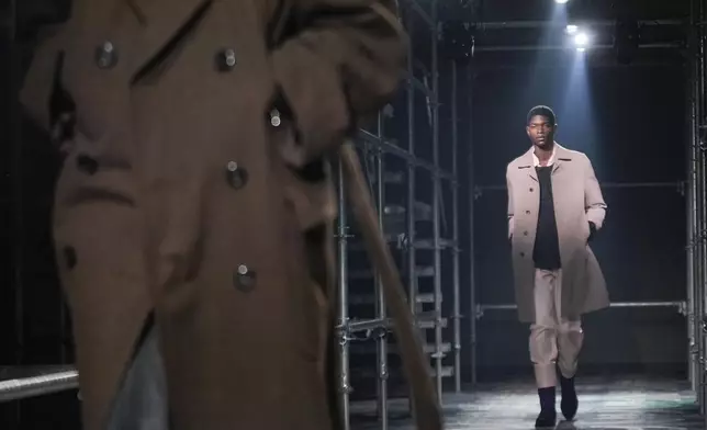 A model wears a creation part of the men's Prada Fall-Winter 2025-2026 collection, that was presented in Milan, Italy, Sunday, Jan. 19, 2025. (AP Photo/Luca Bruno)