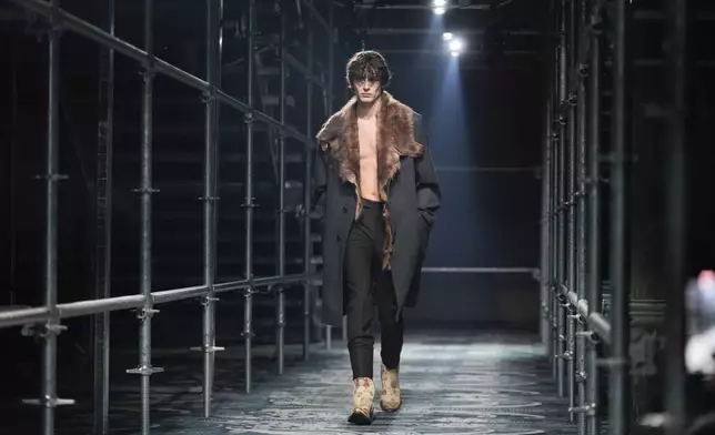 A model wears a creation part of the men's Prada Fall-Winter 2025-2026 collection, that was presented in Milan, Italy, Sunday, Jan. 19, 2025. (AP Photo/Luca Bruno)