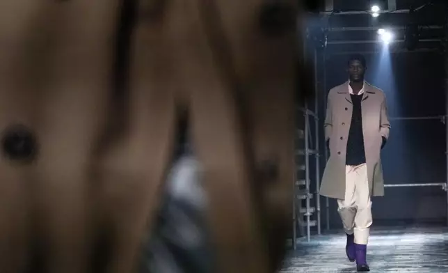 A model wears a creation part of the men's Prada Fall-Winter 2025-2026 collection, that was presented in Milan, Italy, Sunday, Jan. 19, 2025. (AP Photo/Luca Bruno)