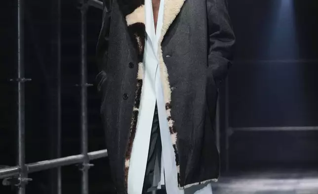 A model wears a creation part of the men's Prada Fall-Winter 2025-2026 collection, that was presented in Milan, Italy, Sunday, Jan. 19, 2025. (AP Photo/Luca Bruno)