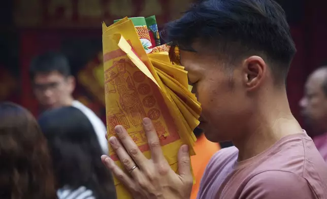 Malaysian ethnic Chinese pray on the first day of Lunar New Year at Guandi Temple, in Kuala Lumpur, Malaysia, Wednesday, Jan. 29, 2025. (AP Photo/Vincent Thian)