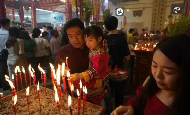 Chinese people offer candles and pray at a temple during their New Year day of the Snake at Chinatown in Yangon, Myanmar, Wednesday, Jan. 29, 2025. (AP Photo/Thein Zaw)