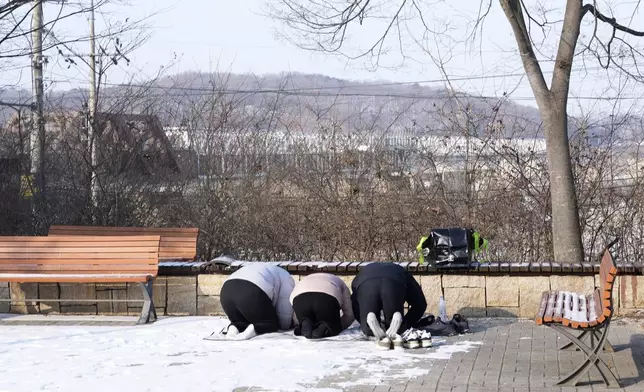 People bow to respect for their ancestors in North Korea, on the Lunar New Year near the military barbed-wire fence at the Imjingak Pavilion in Paju, South Korea, Wednesday, Jan. 29, 2025. (AP Photo/Lee Jin-man)