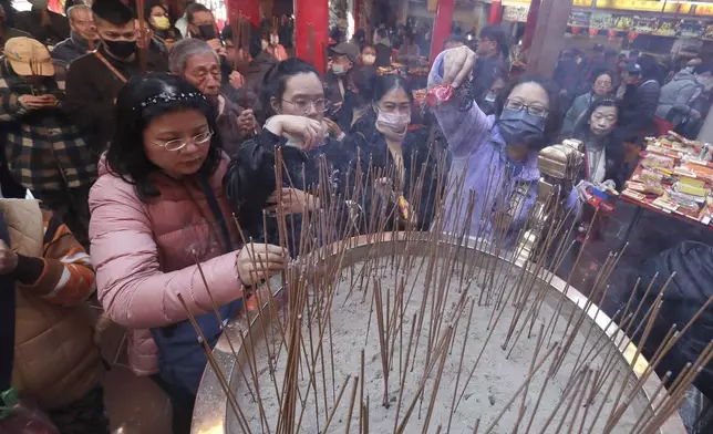 Worshippers visit a temple to pray on the first day of the Lunar New Year celebrations in Taipei, Taiwan, Wednesday, Jan. 29, 2025. (AP Photo/Chiang Ying-ying)