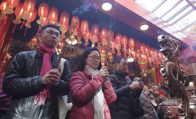 Worshippers visit a temple to pray on the first day of the Lunar New Year celebrations in Taipei, Taiwan, Wednesday, Jan. 29, 2025. (AP Photo/Chiang Ying-ying)