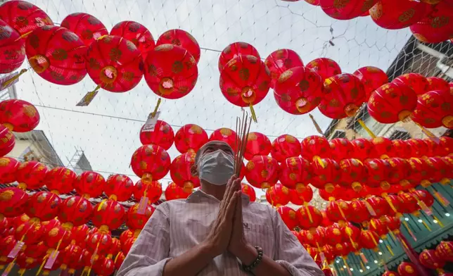 An Ethnic Chinese Thai prays at Kwong Siew Shrine to celebrate the Lunar New Year in Bangkok, Thailand, Wednesday, Jan. 29, 2025. (AP Photo/Sakchai Lalit)