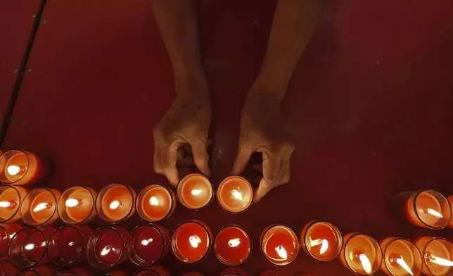 Ethnic Chinese Thai lay down candles after praying at the Leng Nuei Yee temple to celebrate the Lunar New Year in Bangkok, Thailand, Wednesday, Jan. 29, 2025. (AP Photo/Sakchai Lalit)