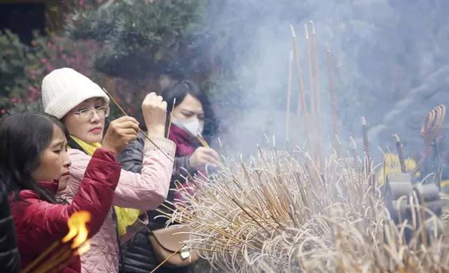 People place incenses at Quan Su pagoda on the first day of the Lunar New Year in Hanoi, Vietnam Wednesday, Jan. 29, 2025. (AP Photo/Hau Dinh)