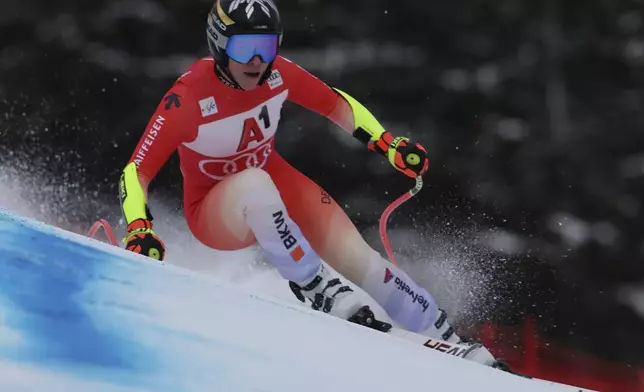 Switzerland's Lara Gut Behrami speeds down the course during an alpine ski, women's World Cup super G race, in St. Anton, Austria, Sunday, Jan. 12, 2025. (AP Photo/Marco Trovati)