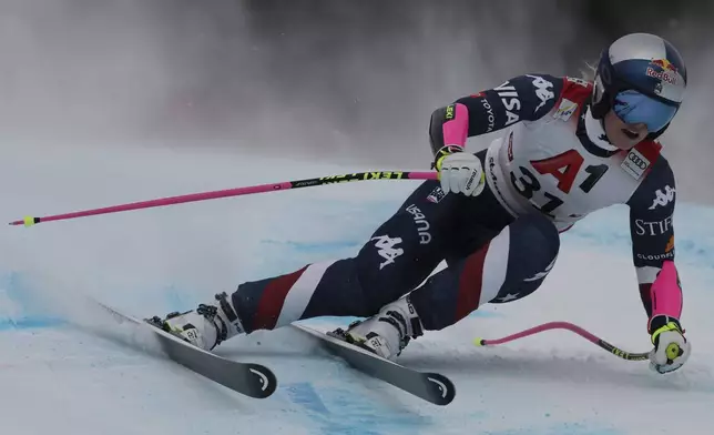 United States Lindsey Vonn speeds down the course during an alpine ski, women's World Cup super G race, in St. Anton, Austria, Sunday, Jan. 12, 2025. (AP Photo/Marco Trovati)