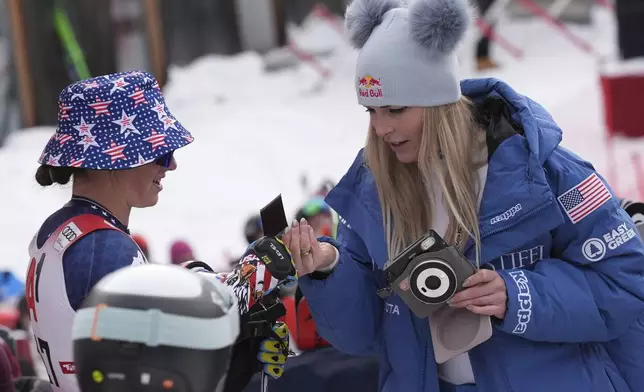 From left, the winner United States' Lauren Macuga and fourth placed Lindsey Von after completing an alpine ski, women's World Cup super G race, in St. Anton, Austria, Sunday, Jan. 12, 2025. (AP Photo/Giovanni Auletta)