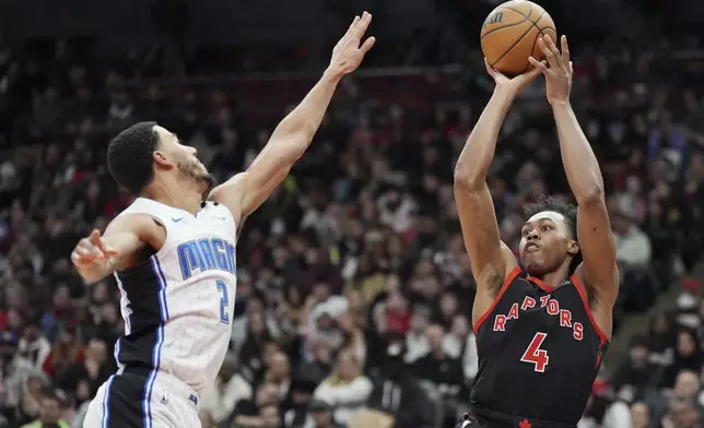 Toronto Raptors forward Scottie Barnes (4) shoots over Orlando Magic guard Caleb Houstan (2) during the first half of an NBA basketball game, Friday, Jan. 3, 2025 in Toronto. (Frank Gunn/The Canadian Press via AP)