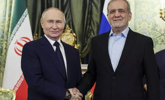 Russian President Vladimir Putin, left, and Iranian President Masoud Pezeshkian pose for a photo during their meeting at the Kremlin in Moscow, Russia, Friday, Jan. 17, 2025. (Vyacheslav Prokofyev, Sputnik, Kremlin Pool Photo via AP)