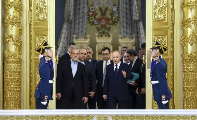 Iranian President Masoud Pezeshkian, center left,, and Russian President Vladimir Putin, center right, arrive to attend a signing ceremony following their talks at the Kremlin in Moscow, Russia, Friday, Jan. 17, 2025. (Vyacheslav Prokofyev, Sputnik, Kremlin Pool Photo via AP)