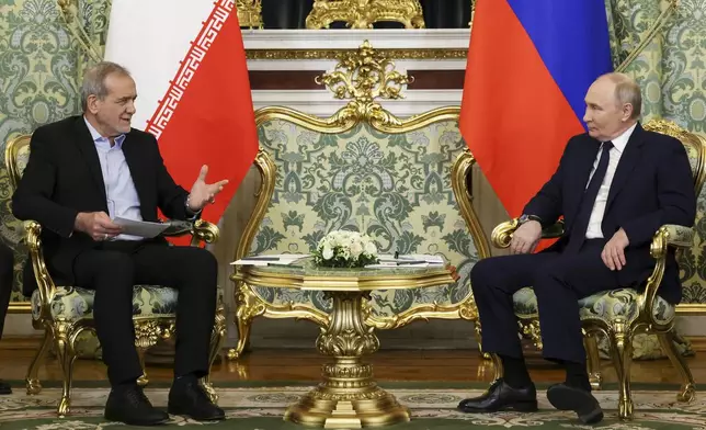 Russian President Vladimir Putin, right, and Iranian President Masoud Pezeshkian talk to each other during their meeting at the Kremlin in Moscow, Russia, Friday, Jan. 17, 2025. (Vyacheslav Prokofyev, Sputnik, Kremlin Pool Photo via AP)