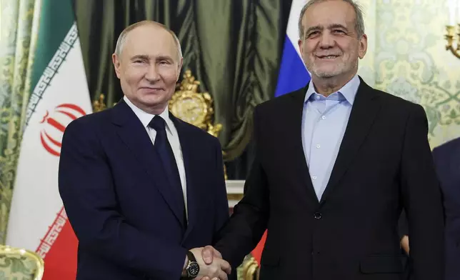 Russian President Vladimir Putin, left, and Iranian President Masoud Pezeshkian pose for a photo during their meeting at the Kremlin in Moscow, Russia, Friday, Jan. 17, 2025. (Vyacheslav Prokofyev, Sputnik, Kremlin Pool Photo via AP)