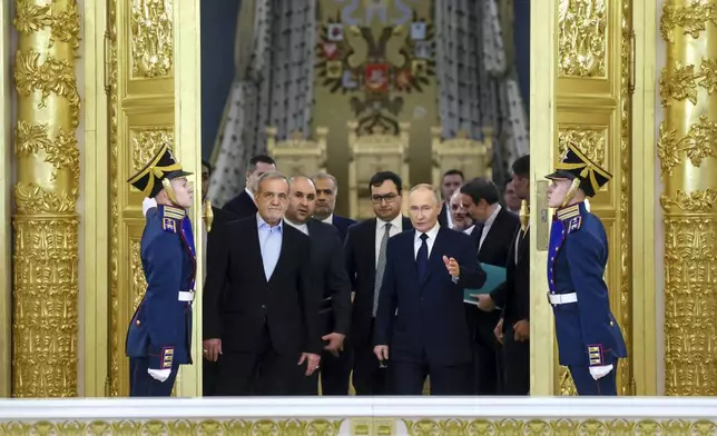 Iranian President Masoud Pezeshkian, center left,, and Russian President Vladimir Putin, center right, arrive to attend a signing ceremony following their talks at the Kremlin in Moscow, Russia, Friday, Jan. 17, 2025. (Vyacheslav Prokofyev, Sputnik, Kremlin Pool Photo via AP)