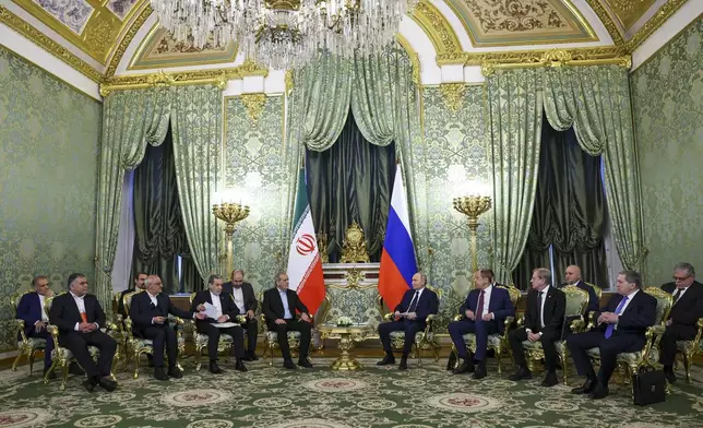 Russian President Vladimir Putin, center right, and Iranian President Masoud Pezeshkian, center left, attend talks at the Kremlin in Moscow, Russia, Friday, Jan. 17, 2025. (Evgenia Novozhenina/Pool Photo via AP)
