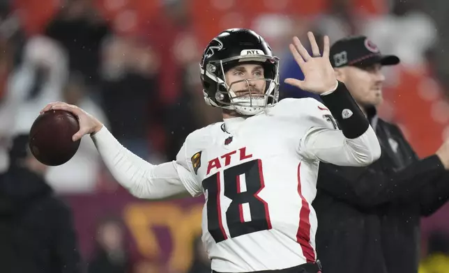 Atlanta Falcons quarterback Kirk Cousins (18) warms up before an NFL football game against the Washington Commanders, Sunday, Dec. 29, 2024, in Landover. (AP Photo/Stephanie Scarbrough)