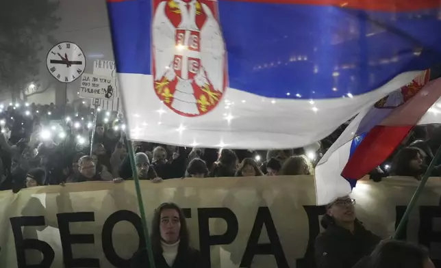 Students march on New Years Eve during a protest that erupted after a concrete canopy fell two months ago and killed 15 people in Belgrade, Serbia, Tuesday, Dec. 31, 2024. (AP Photo/Darko Vojinovic)