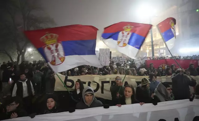 Students march on New Years Eve during a protest that erupted after a concrete canopy fell two months ago and killed 15 people in Belgrade, Serbia, Tuesday, Dec. 31, 2024. (AP Photo/Darko Vojinovic)