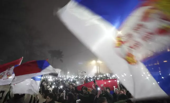 Students march on New Years Eve during a protest that erupted after a concrete canopy fell two months ago and killed 15 people in Belgrade, Serbia, Tuesday, Dec. 31, 2024. (AP Photo/Darko Vojinovic)