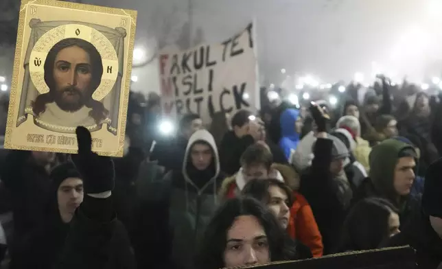 Students march on New Years Eve during a protest that erupted after a concrete canopy fell two months ago and killed 15 people in Belgrade, Serbia, Tuesday, Dec. 31, 2024. (AP Photo/Darko Vojinovic)