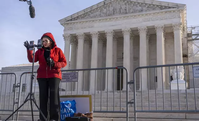 Tiffany Cianci, who says she is a "long form educational content creator," livestreams to TikTok, outside the Supreme Court, Friday, Jan. 10, 2025, in Washington. (AP Photo/Jacquelyn Martin)