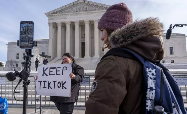 Callie Goodwin, of Columbia, S.C., holds a sign in support of TikTok outside the Supreme Court, Friday, Jan. 10, 2025, in Washington. Goodwin, a small business owner who sells personalized greeting cards, says 80% of her sales come from people who found her on TikTok. (AP Photo/Jacquelyn Martin)