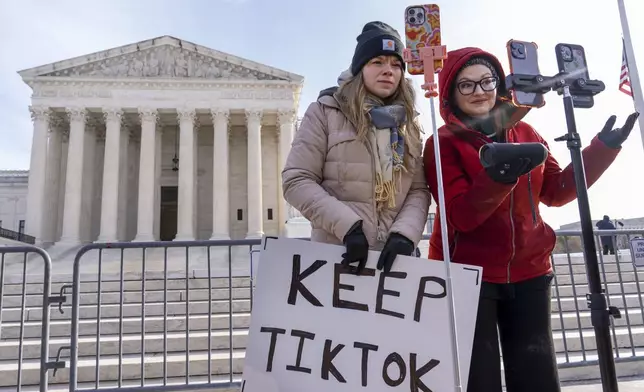 Sarah Baus, left, of Charleston, S.C., and Tiffany Cianci, who says she is a "long-form educational content creator," livestream to TikTok outside the Supreme Court, Friday, Jan. 10, 2025, in Washington. (AP Photo/Jacquelyn Martin)