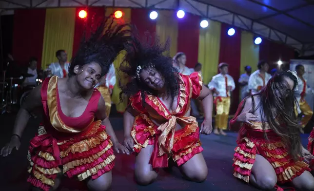 Members of the Paraguay-African cultural group Kamba Cua dance in honor of Saint Balthazar, one of the Three Kings, as they celebrate the upcoming holiday of Epiphany in San Lorenzo on the outskirts of Asuncion, Paraguay, Sunday, Jan. 5, 2025.(AP Photo/Jorge Saenz)