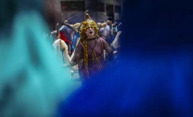 An actress representing the Star of Bethlehem sings during an event celebrating the upcoming holiday of Epiphany in the Plaza de Armas of Santiago, Chile, Sunday, Jan. 5, 2025. (AP Photo/Esteban Felix)