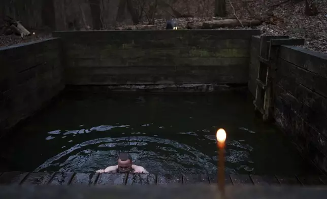 An Orthodox believer bathes in the icy water during celebrations of the Epiphany in Kyiv, Ukraine, Jan. 6, 2025. (AP Photo/Evgeniy Maloletka)