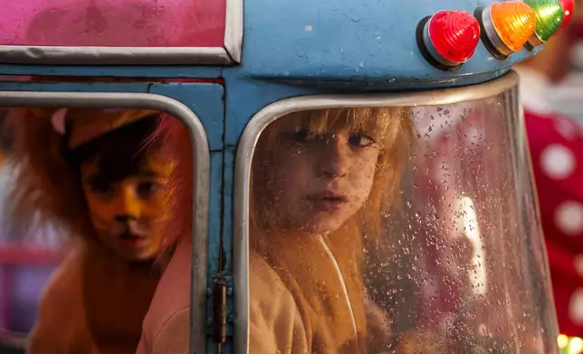 Children attend the traditional "Cabalgata de Reyes" parade in Campo Real, on the outskirts of Madrid, Spain, Sunday, Jan. 5, 2025, as part of the festivities marking the Catholic feast of Epiphany. (AP Photo/Manu Fernandez)