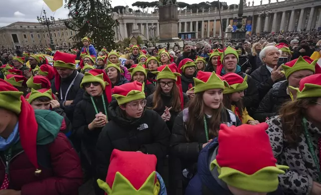 Children pray during the Angelus noon prayer led by Pope Francis on the occasion of the Epiphany day, from the window of his studio overlooking St.Peter's Square, at the Vatican, Monday, Jan. 6, 2025. (AP Photo/Alessandra Tarantino)